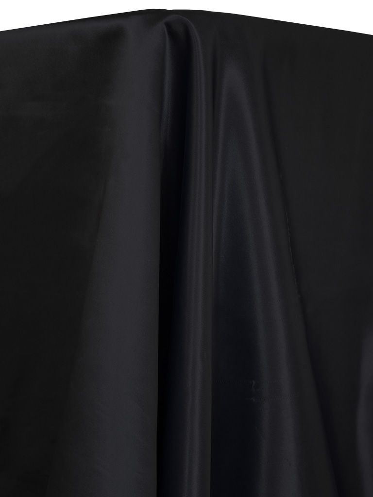 Black fabric draped, showing folds and textures.