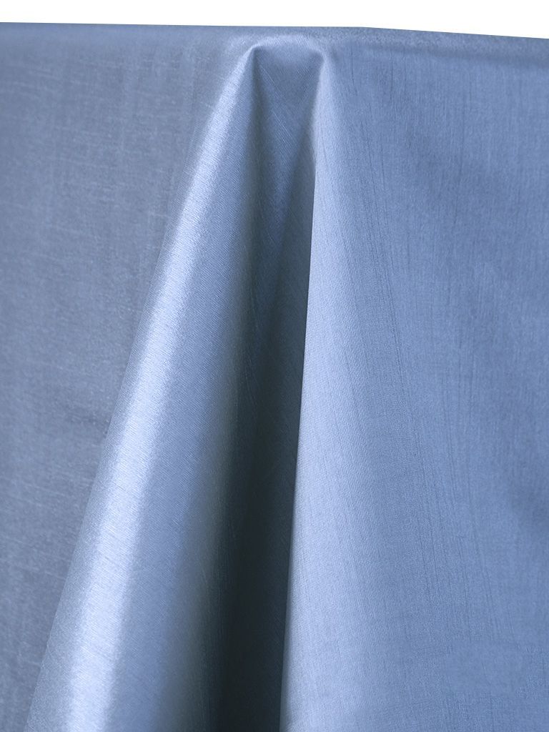 Blue tablecloth draped over a table, with folds and highlights.