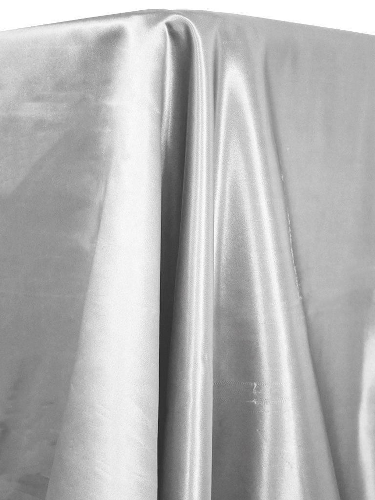 Silver satin tablecloth draped over a table.