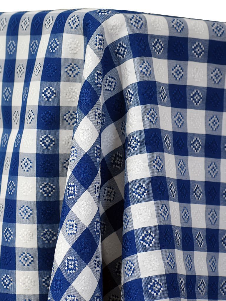 Blue and white checkered tablecloth draped, with diamond patterns in the blue squares.