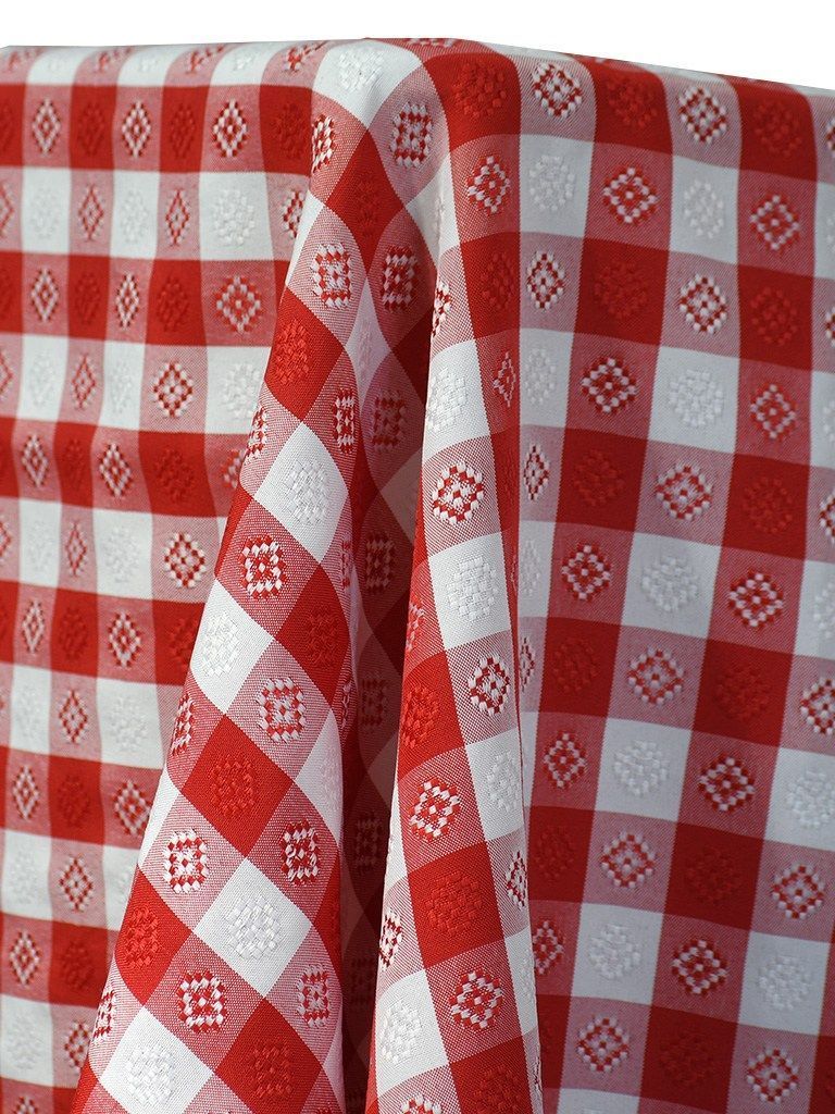 Red and white checkered picnic tablecloth draped over a surface.