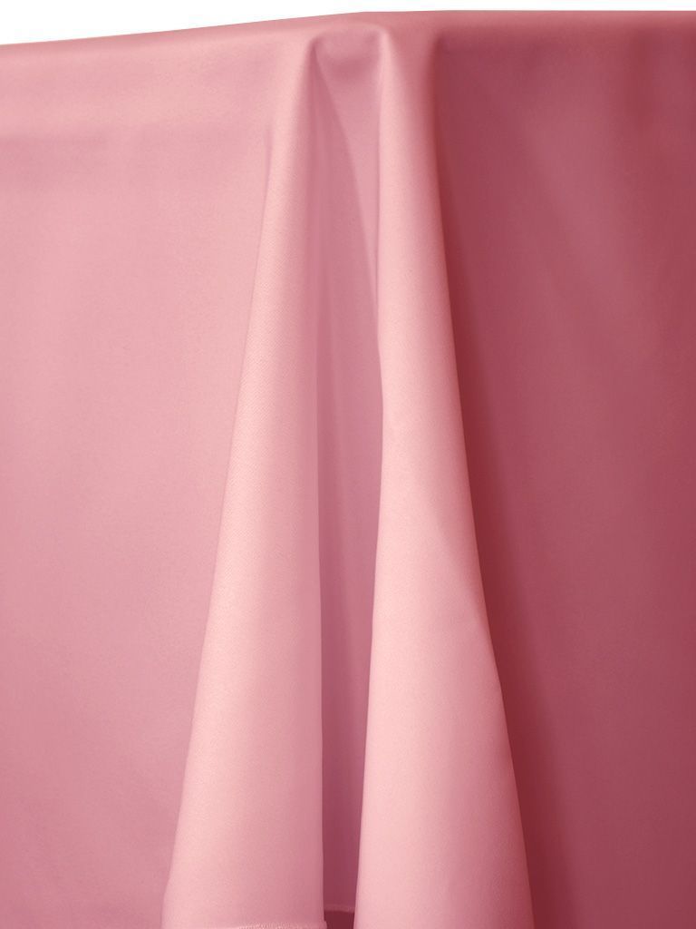 Pink fabric draped over a surface, with folds creating shadows.