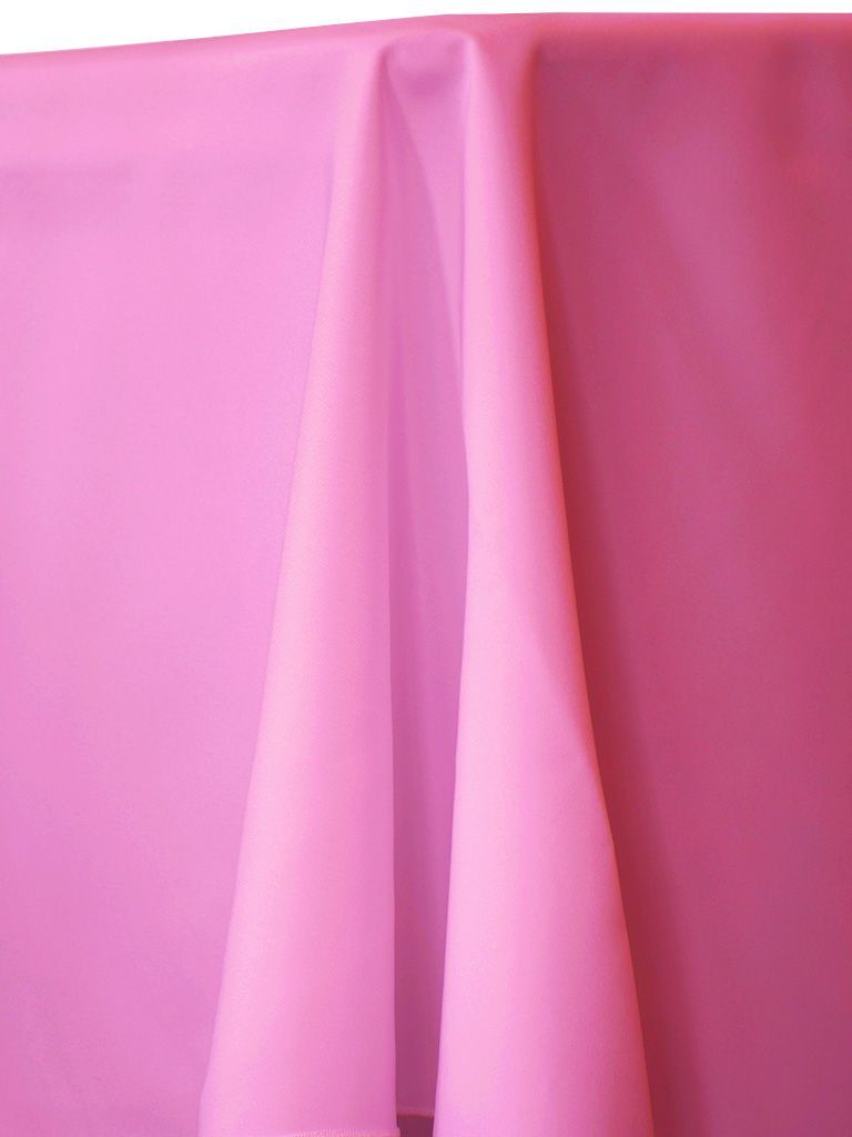Pink fabric draped over a surface, with folds creating shadows.