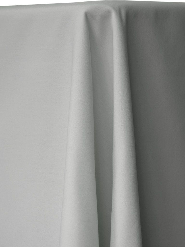 White tablecloth draped over a table, showing folds and shadows.