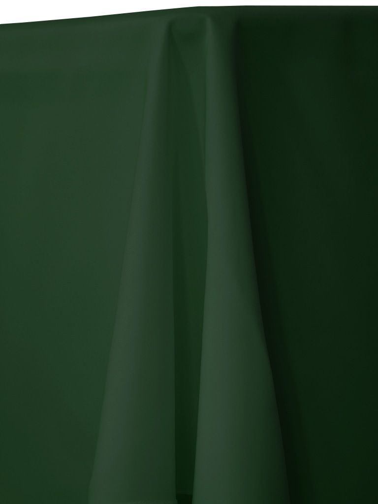 Dark green tablecloth draped over a table, creating soft folds.