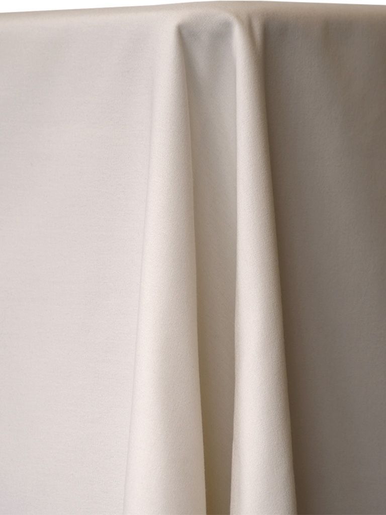 White tablecloth draped over a surface, with folds creating shadows.