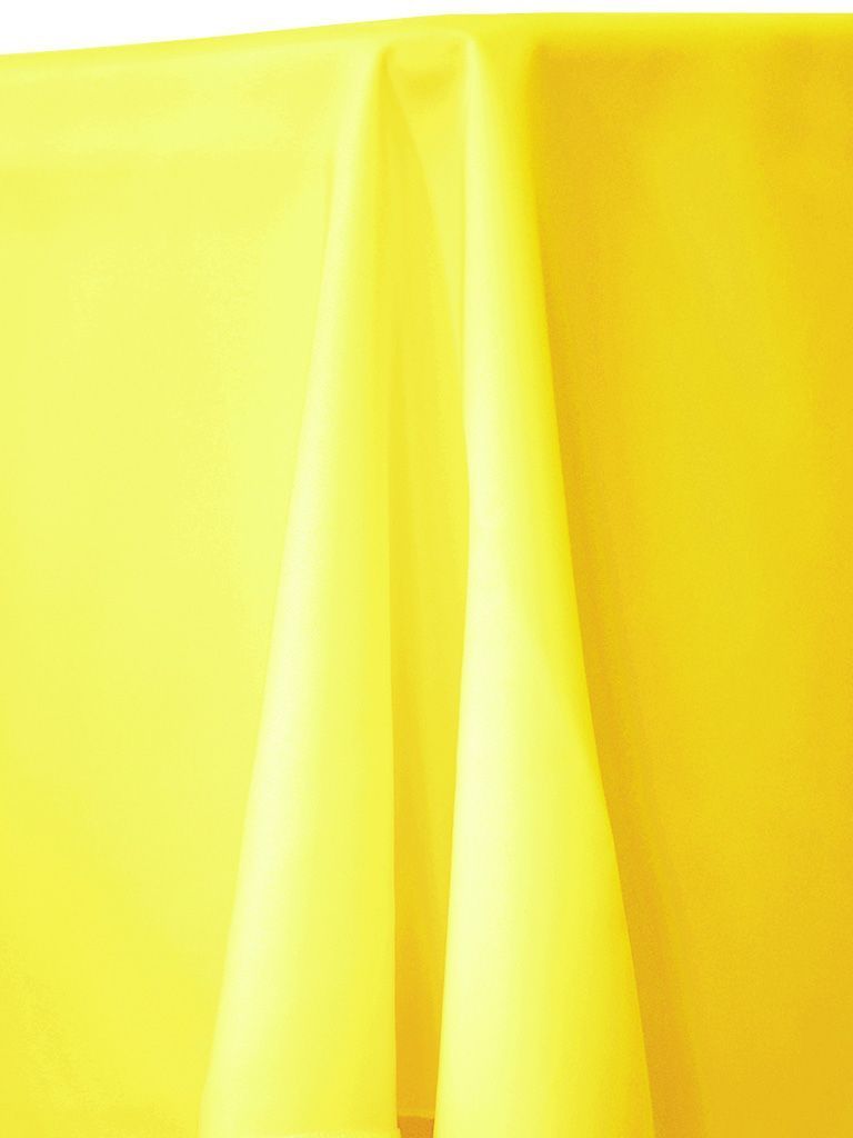 Yellow tablecloth draped over a table, with folds and shadows visible.