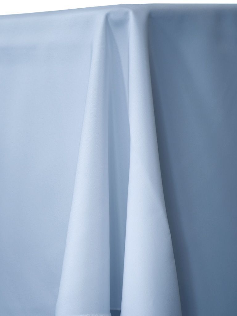 White tablecloth draped over a table, with folds and shadows visible.