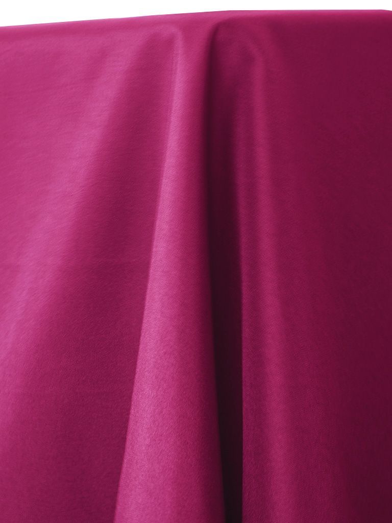 Close-up of vibrant magenta fabric with soft folds and subtle sheen.