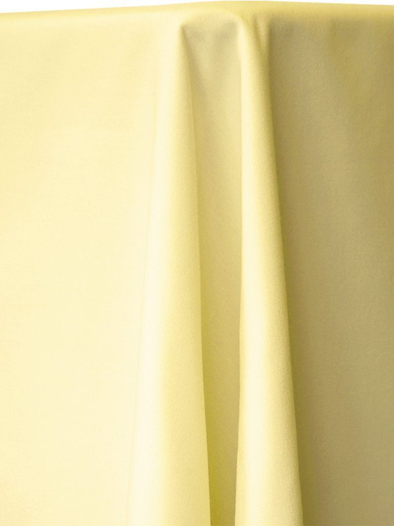 Yellow tablecloth draped over a surface, with folds creating shadows.