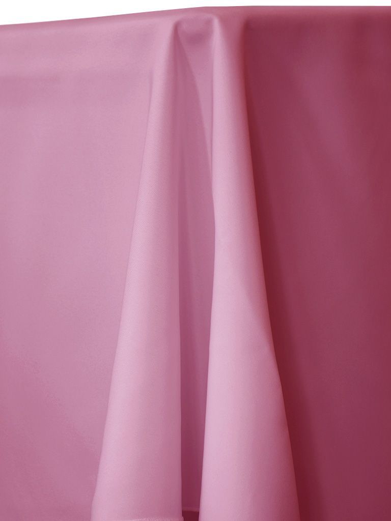 Pink tablecloth draped over a surface, with folds creating shadows.