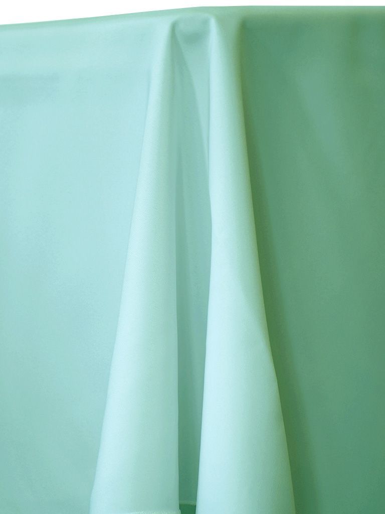 Light green fabric draped on a surface.