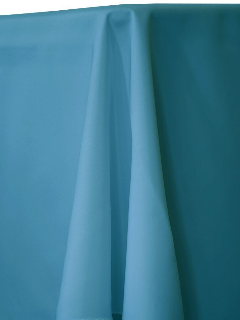 A light-blue draped fabric, possibly a tablecloth, with soft folds and shadows.