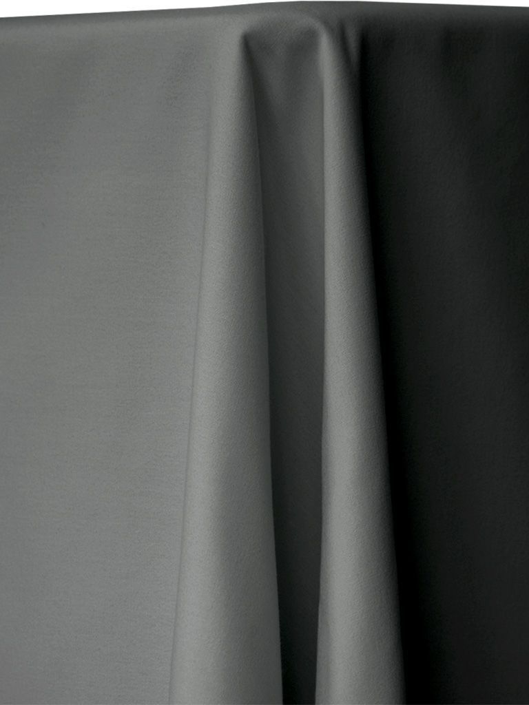 Gray fabric draped over a table, showing folds and shadows.