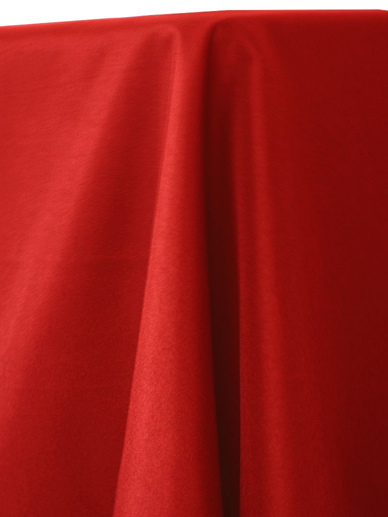 Red fabric draped, with visible folds and slight texture.