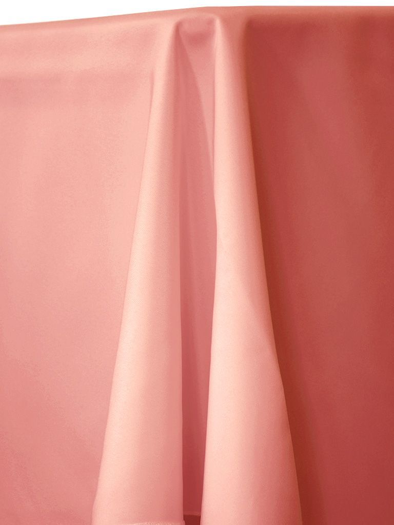 Pink tablecloth draping over a table, with folds and shadows visible.