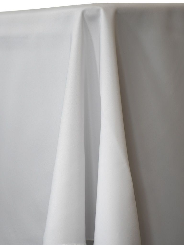 White tablecloth draped over a table, with folds and shadows.