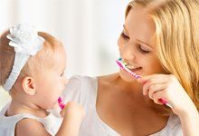 Mother and baby happy toothbrushing