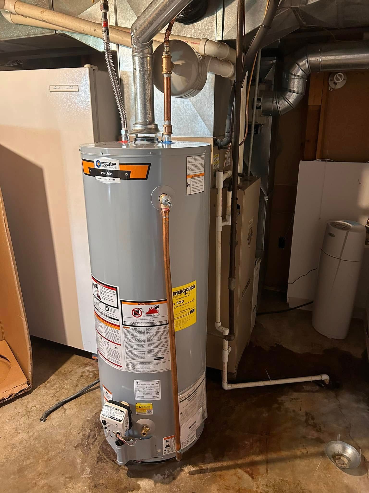 A water heater in a basement, surrounded by pipes, a furnace, and other utilities.