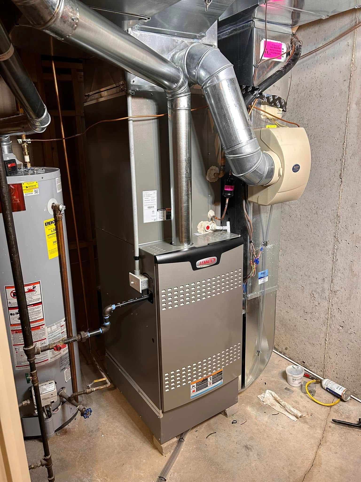 Gas furnace and water heater in a basement.