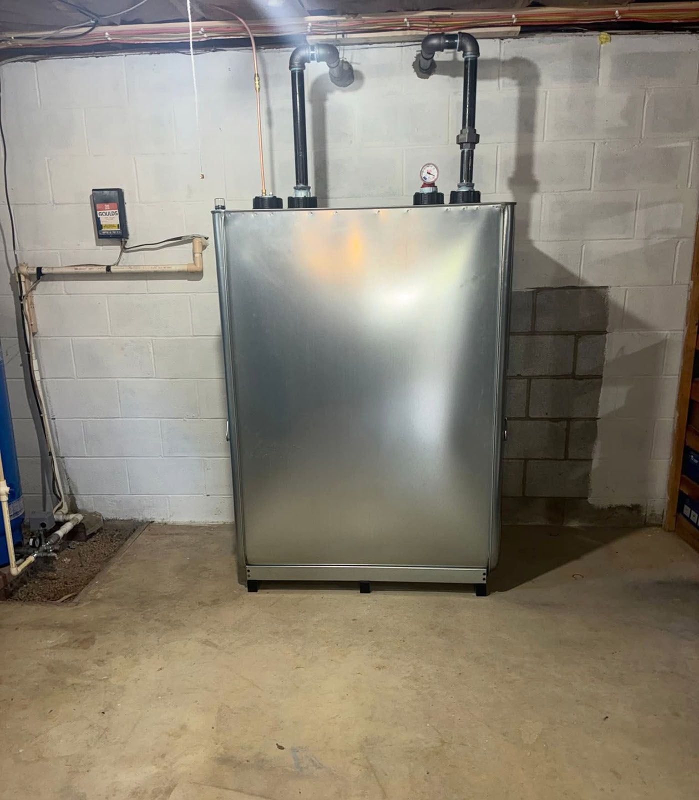 Silver oil tank in a concrete basement