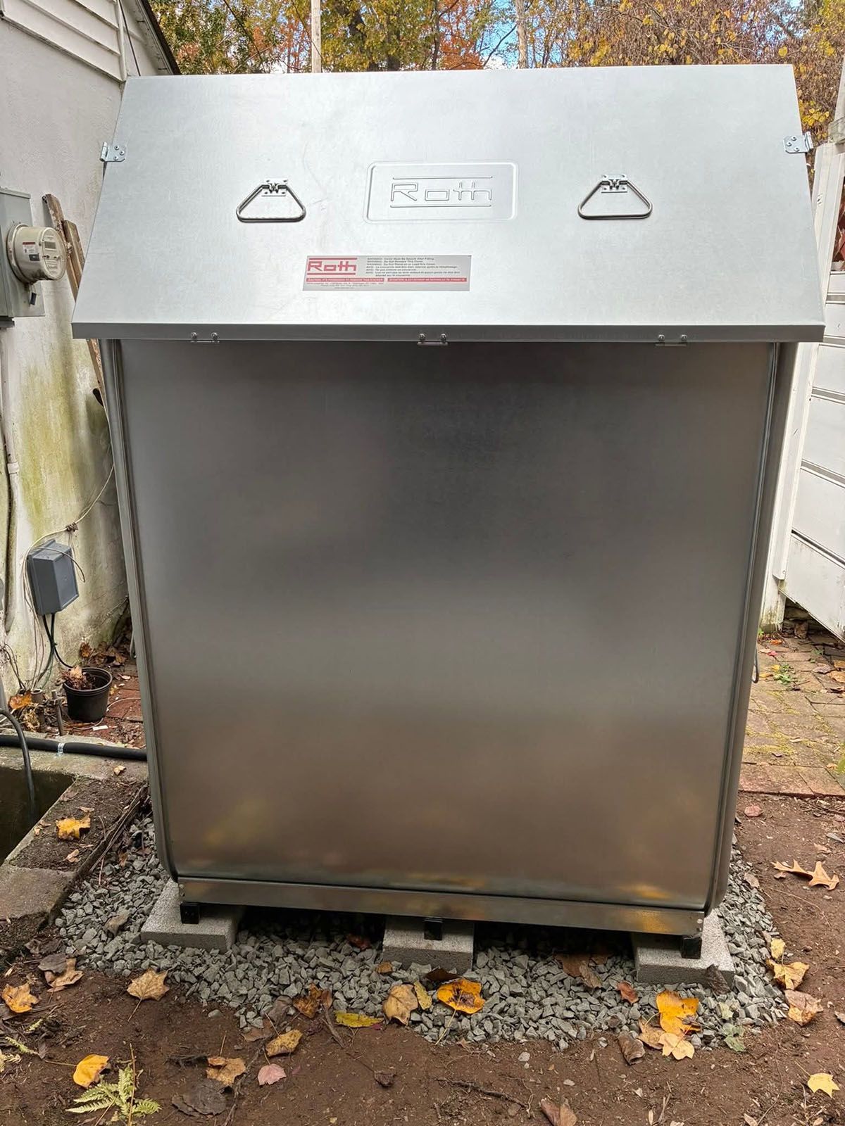 Metal oil tank outdoors, on a gravel base