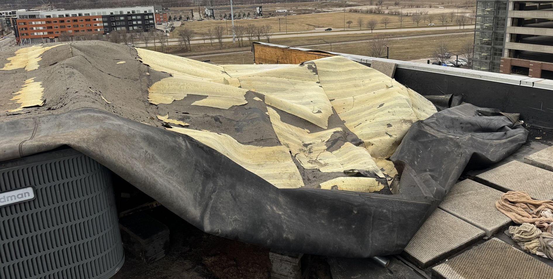 Wind damaged flat roof on an apartment  building in Des Moines, IA.