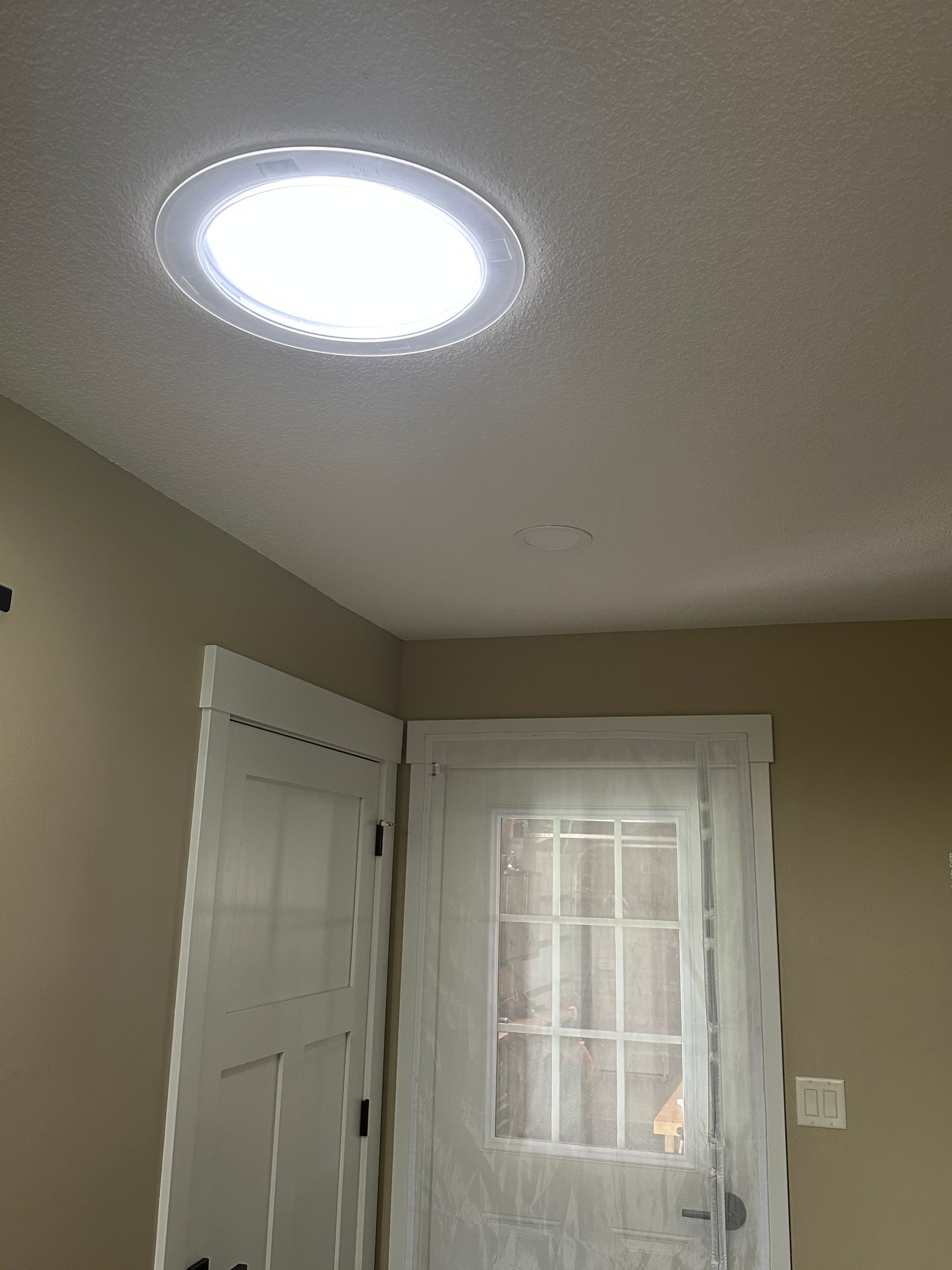 Sun tunnel installation in a dark entry to provide natural light in Saint Ansgar, IA.