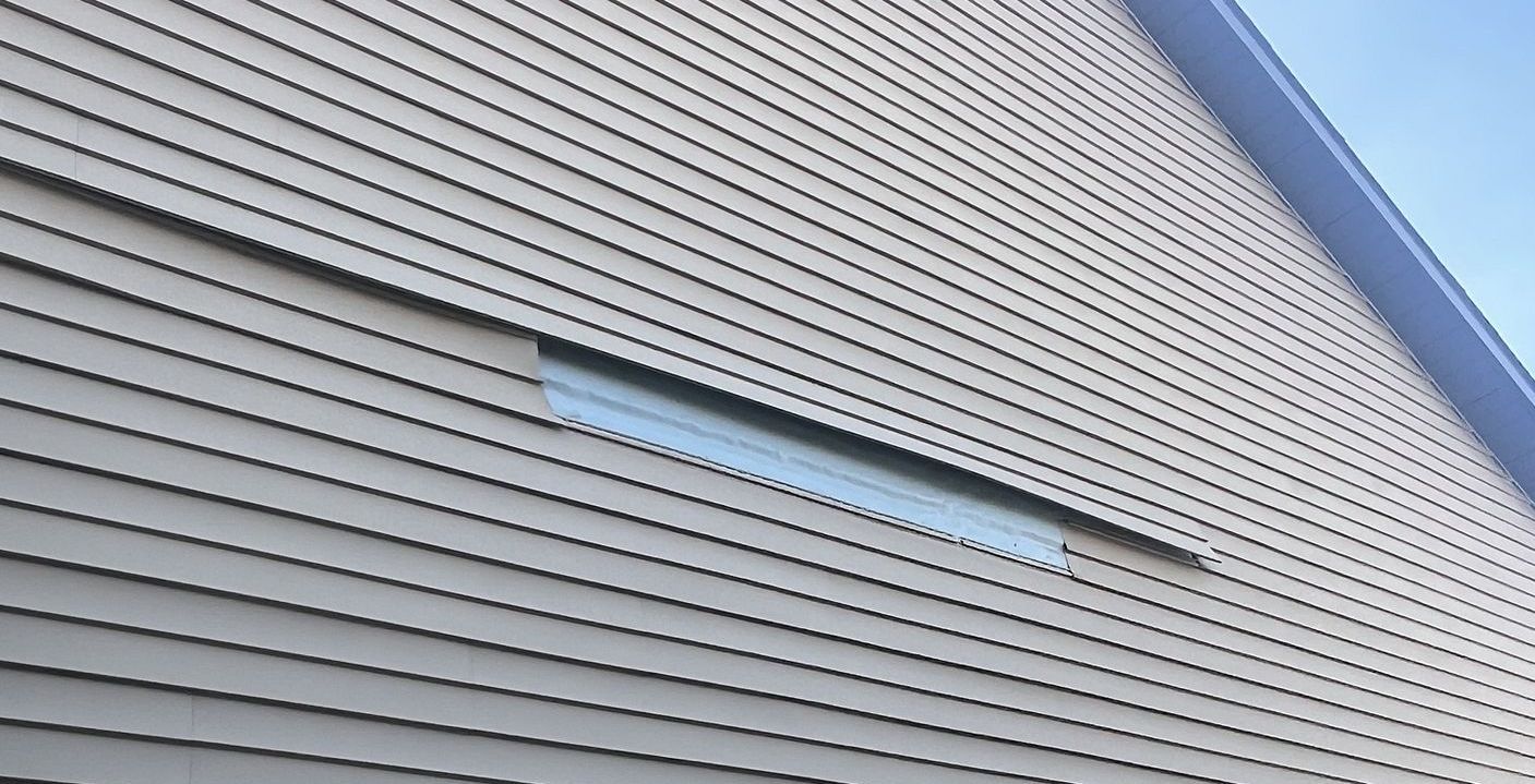 Missing siding on the home in Urbandale, IA that needs siding repairs.