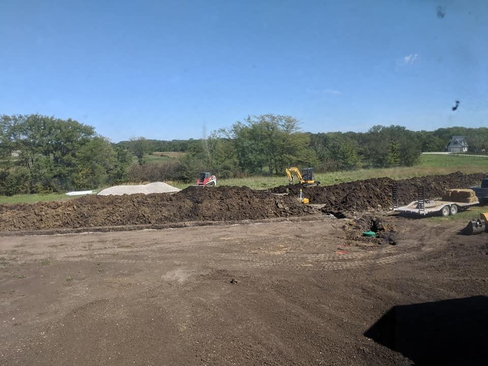 A large pile of dirt is sitting on top of a dirt field.