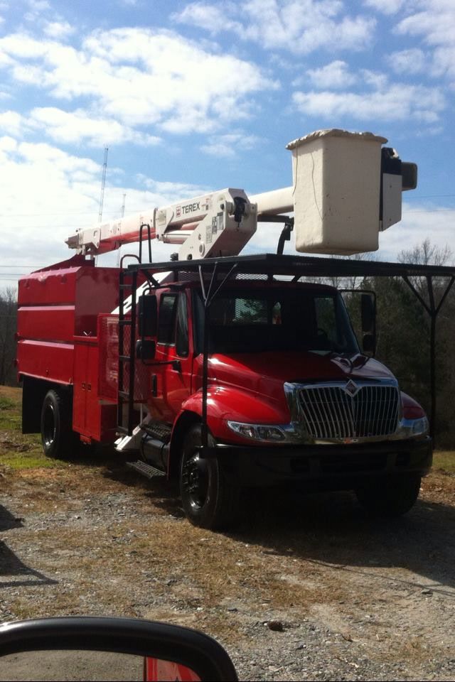 A red truck with a bucket on top of it