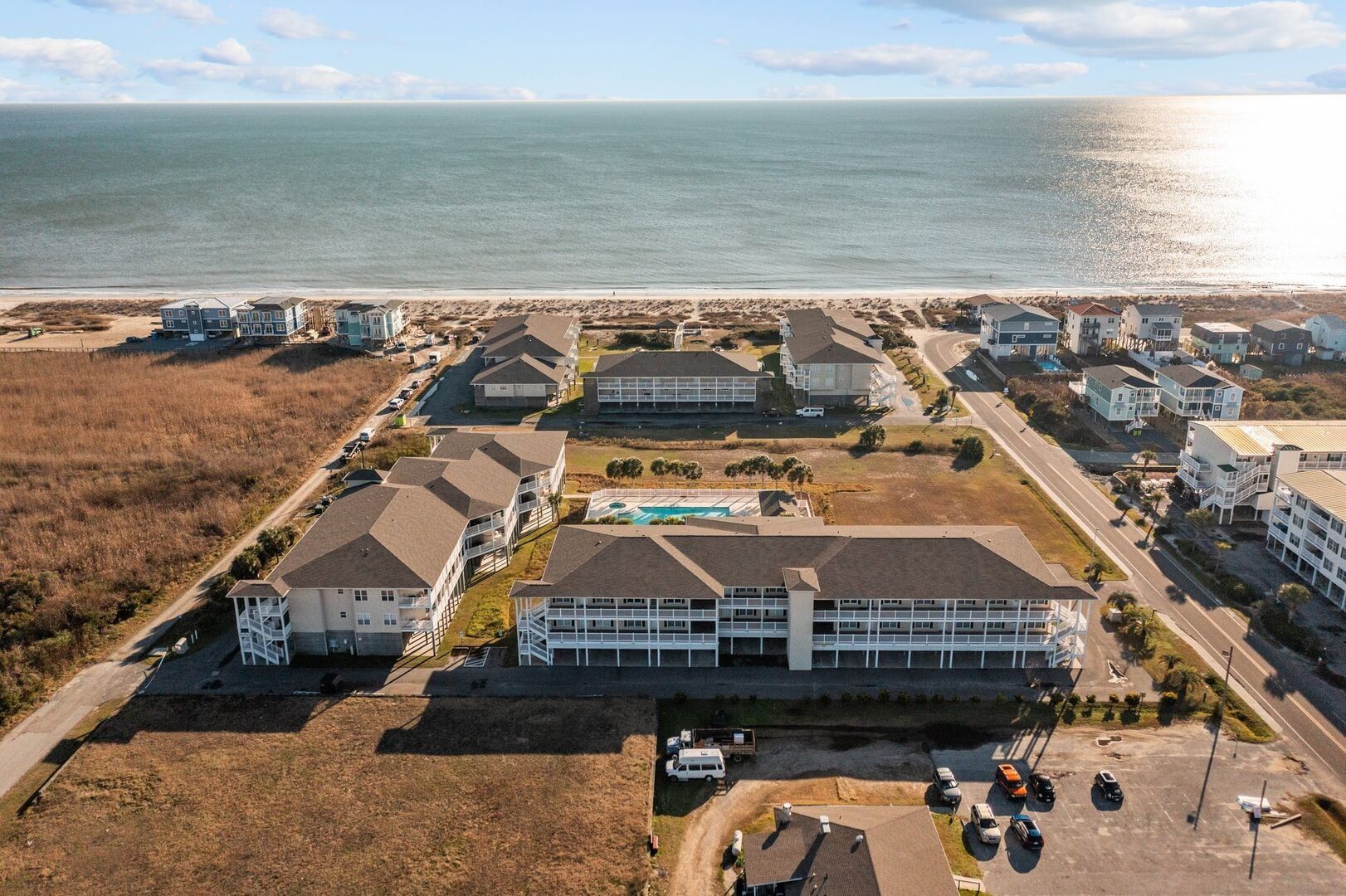 Aerial view of beachfront buildings beside the ocean on a sunny day