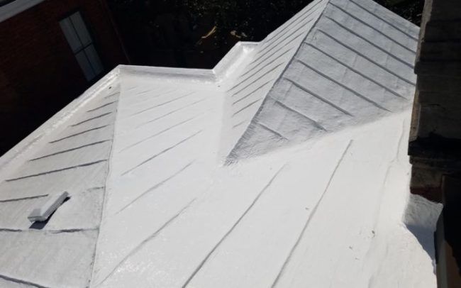 White painted metal roof with ridges and a flat section.