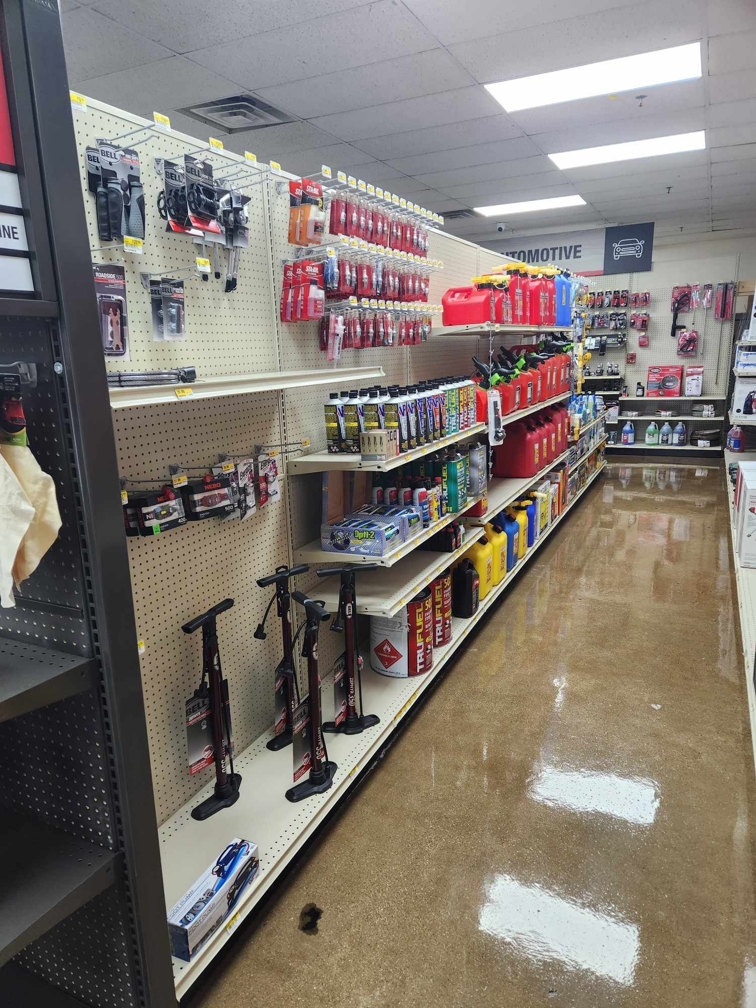 A row of shelves in a store filled with lots of products.