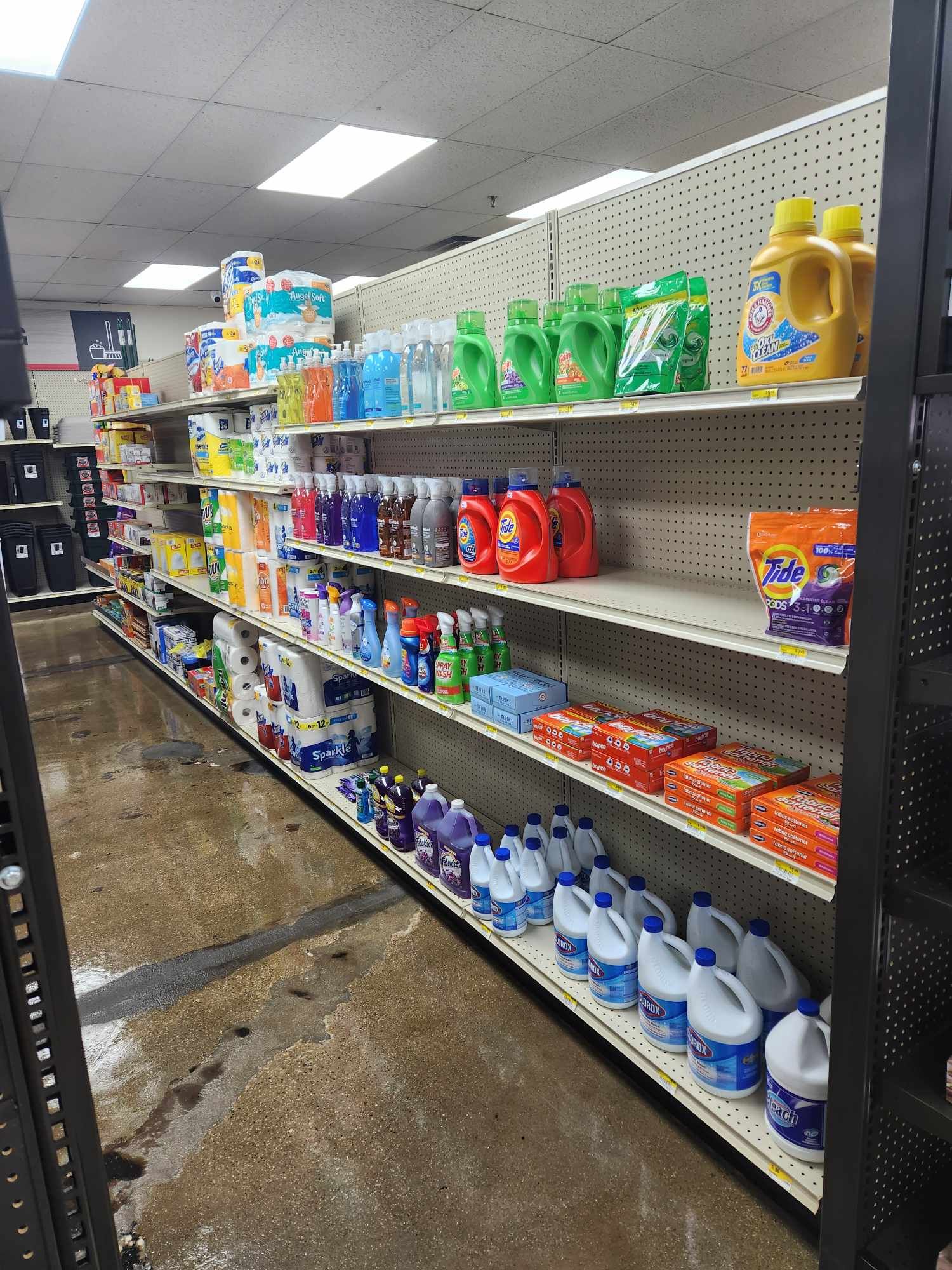 A grocery store aisle filled with lots of cleaning supplies.
