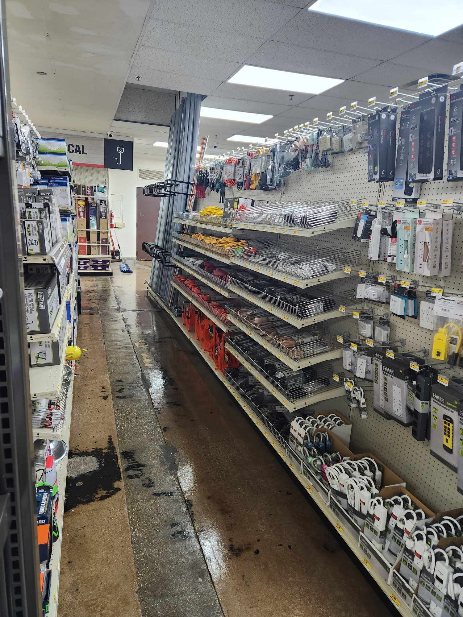 The inside of a hardware store with shelves filled with lots of items.