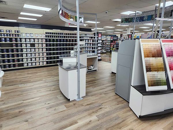 A paint store with a lot of shelves and displays of paint.