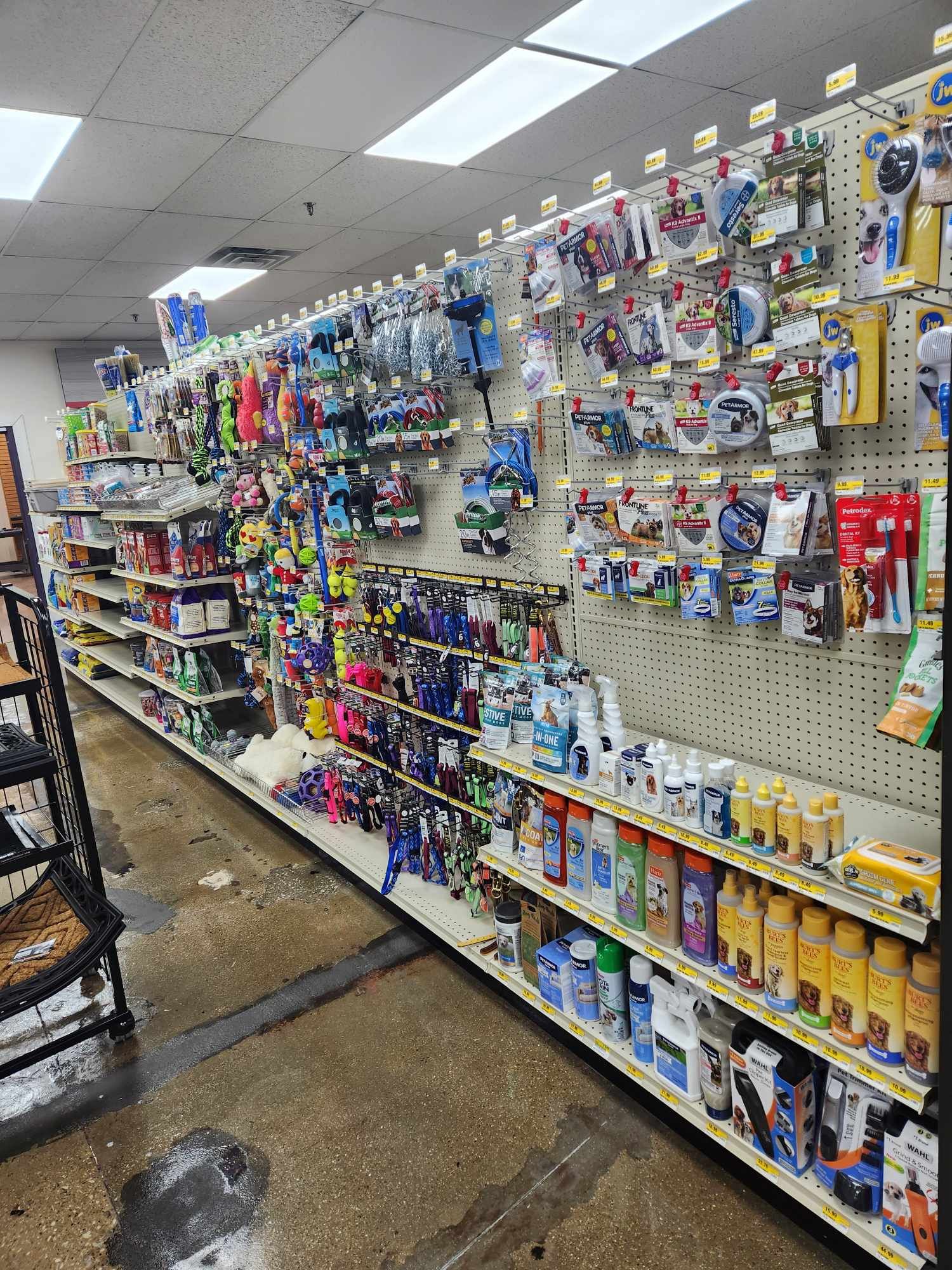 A store aisle filled with lots of pet toys.