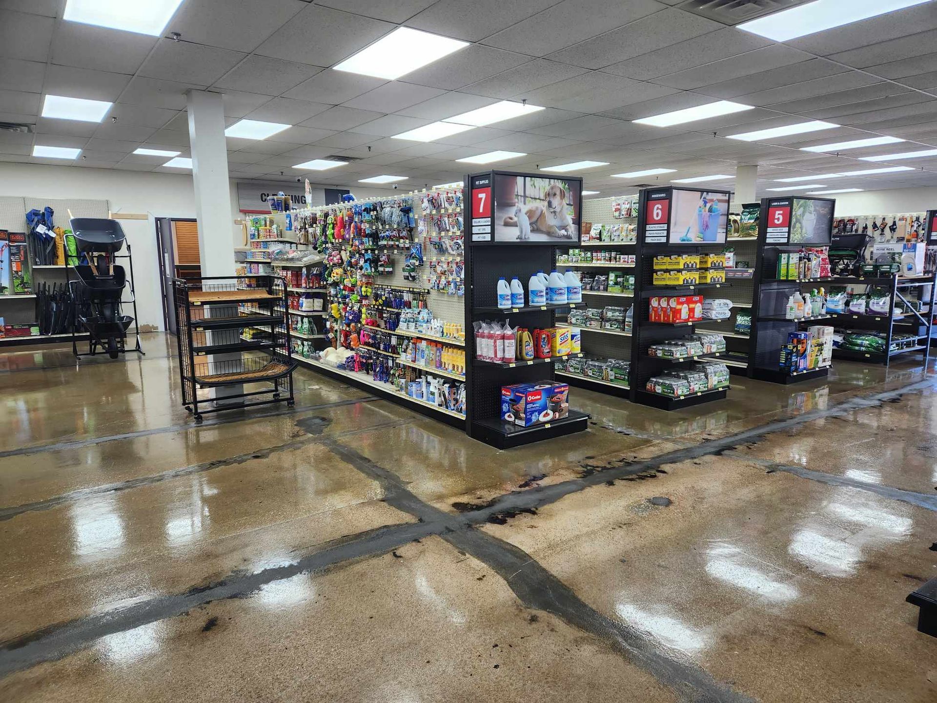 A large store filled with lots of shelves filled with lots of pet products.