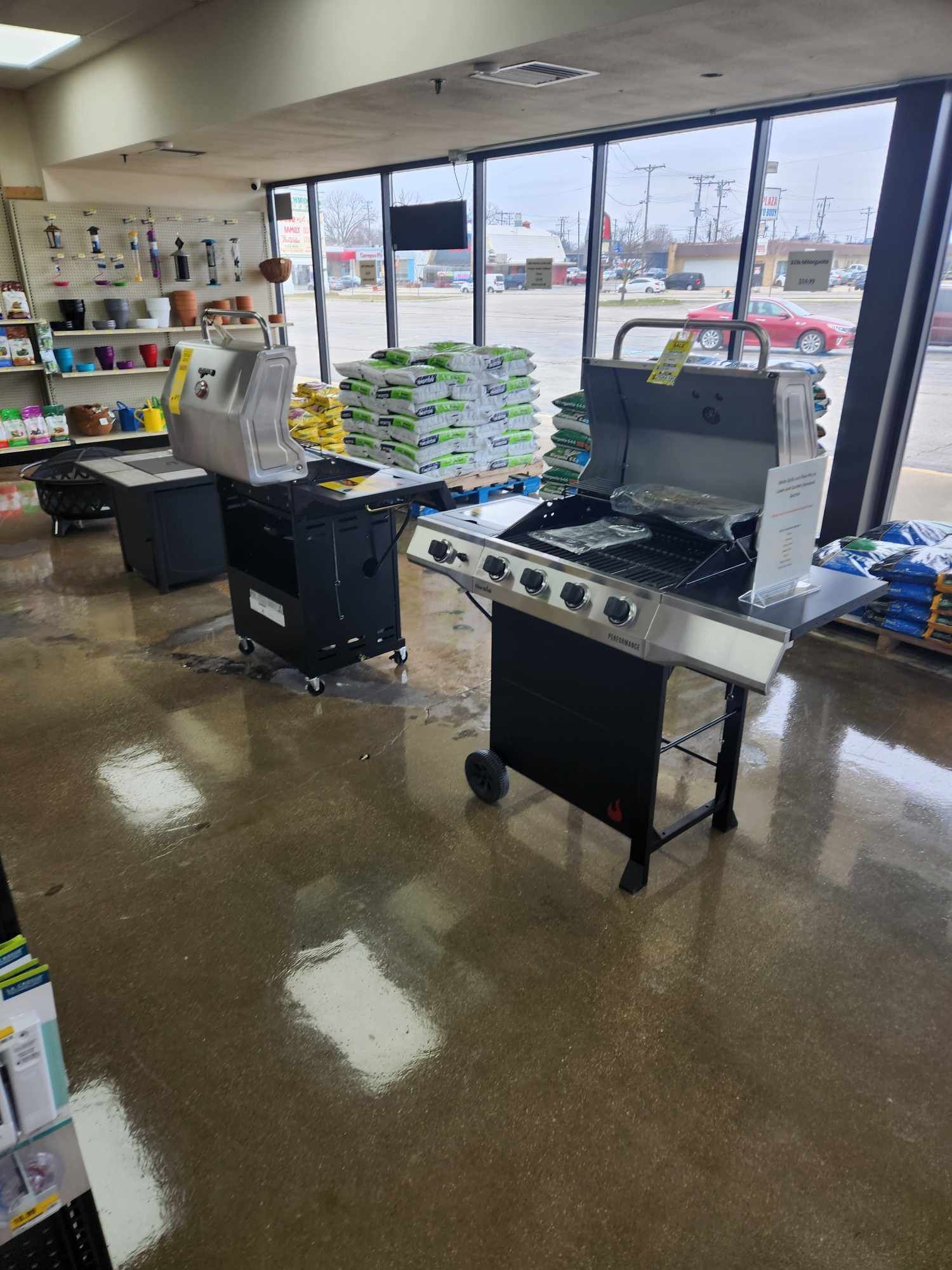 A grill is sitting in the middle of a room in a store.