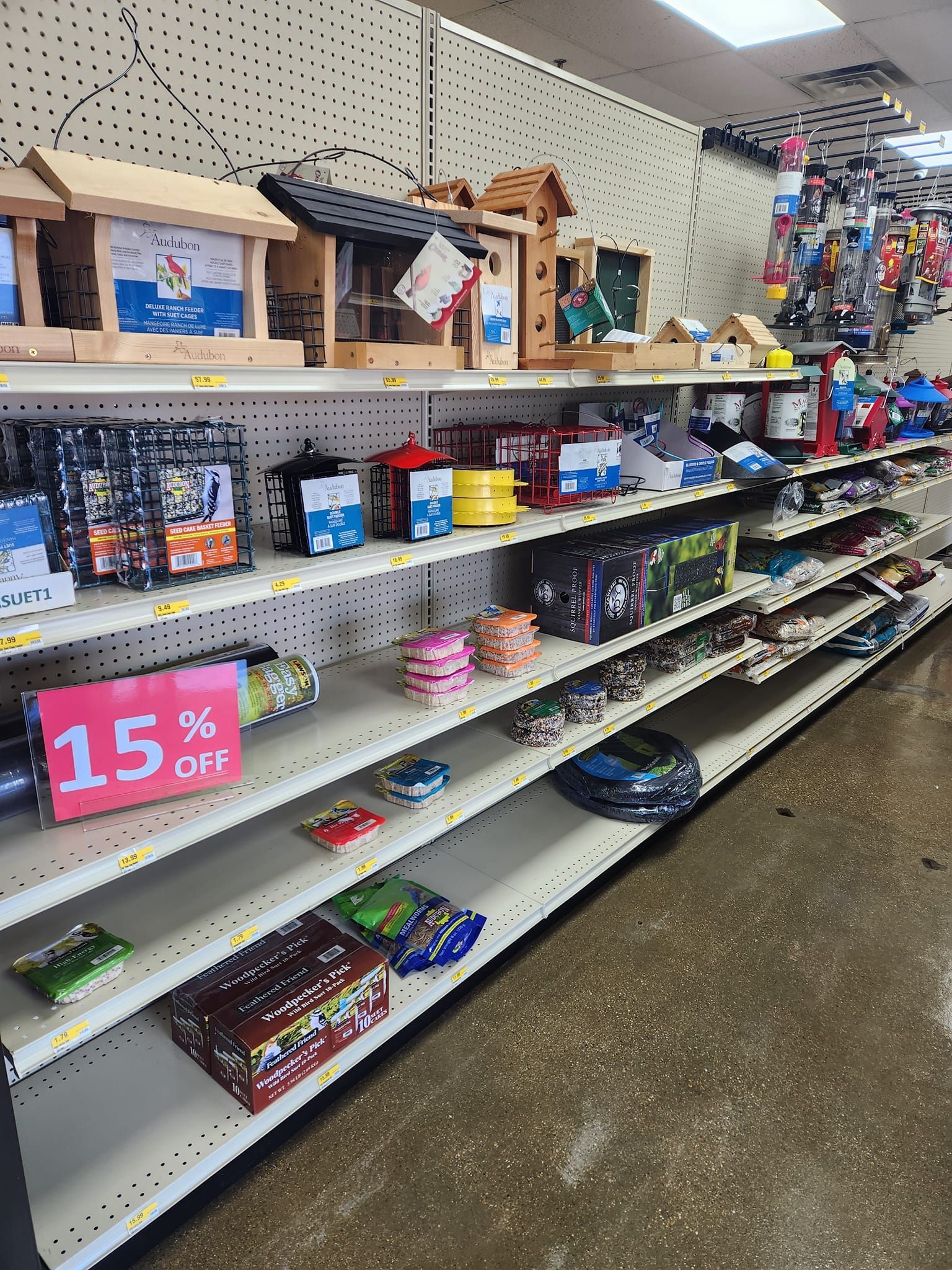 a row of shelves in a store with a sign that says 15 % off 