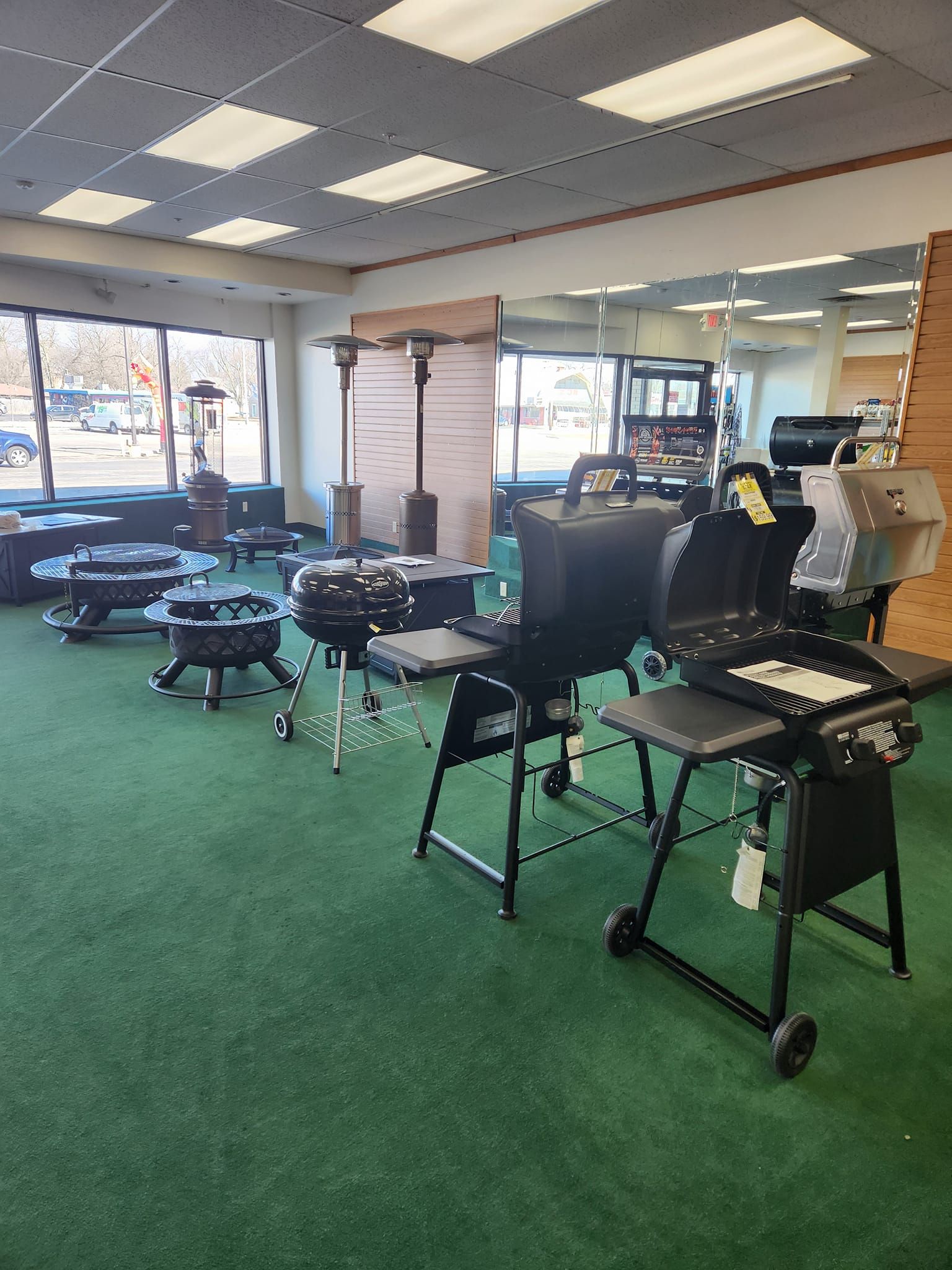 a large room filled with lots of grills and fire pits