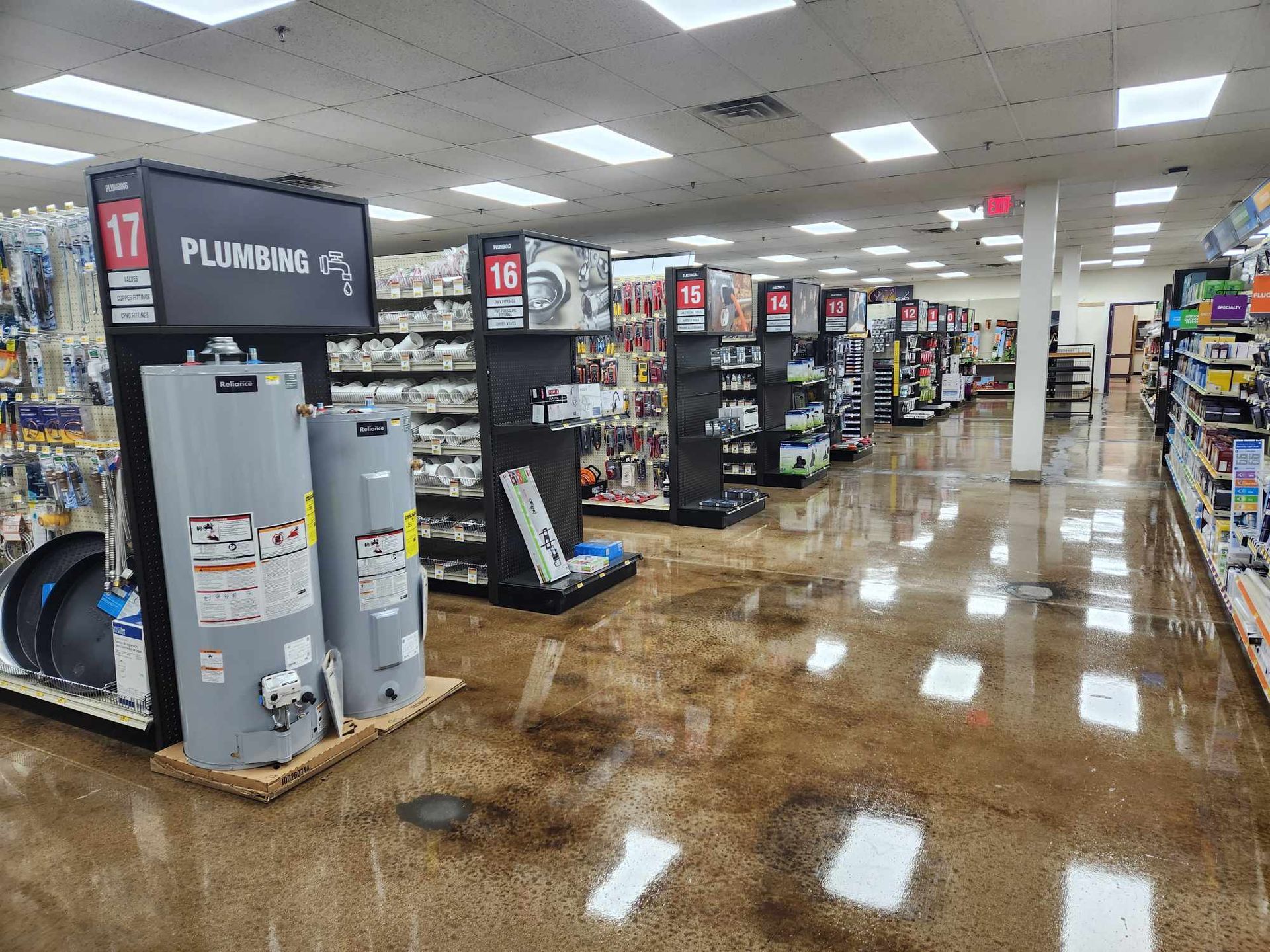 a store filled with lots of shelves and a sign that says plumbing