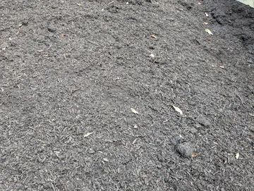 Pile of dark brown mulch.