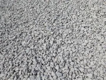 Gray gravel, small, irregularly shaped stones covering a surface.