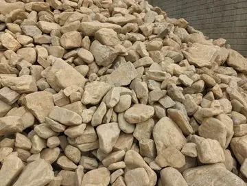 Pile of beige rocks of various sizes, possibly construction aggregate.