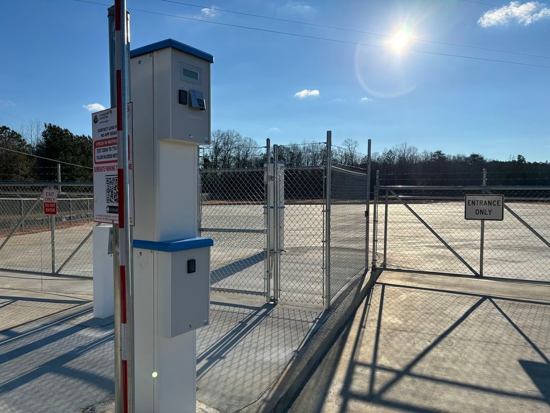 a parking lot with a fence and a gate