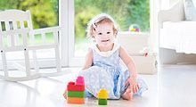 Toddler girl playing with blocks