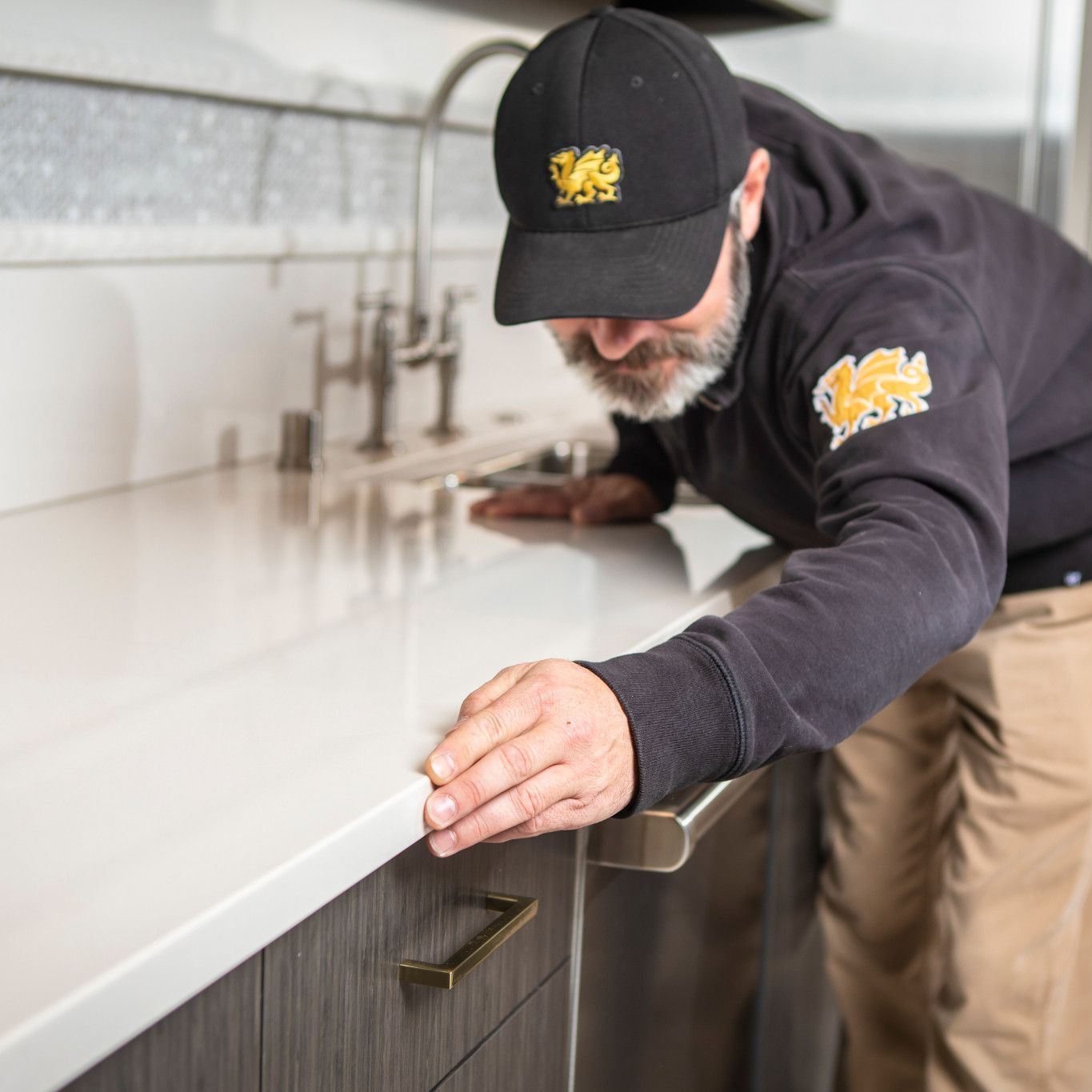 A man wearing a black hat with a welsh dragon on it