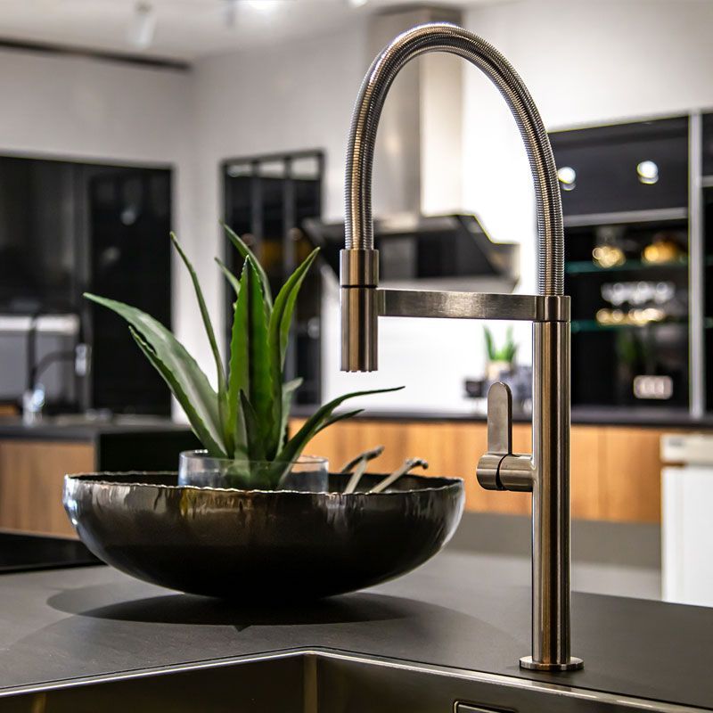 A sink with a plant in it and a faucet